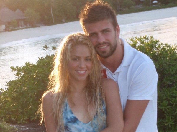 photograph of singer shakira hugged with soccer player gerard piqué