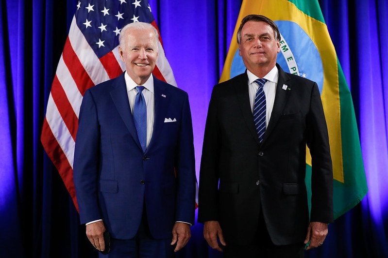 O presidente Bolsonaro posa para foto com o presidente americano Joe Biden na Cúpula das Américas Ao fundo, as bandeiras dos Estados Unidos e Brasil - Metrópoles