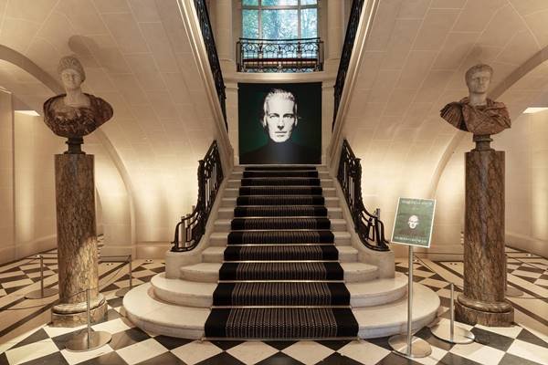 Escadaria da Christie's com uma foto de Hubert de Givenchy 