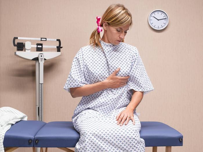 Woman-doing-self-exam for breast cancer- Metropolises