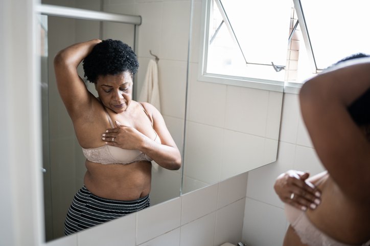 Woman-doing-self-exam for breast cancer- Metropolises