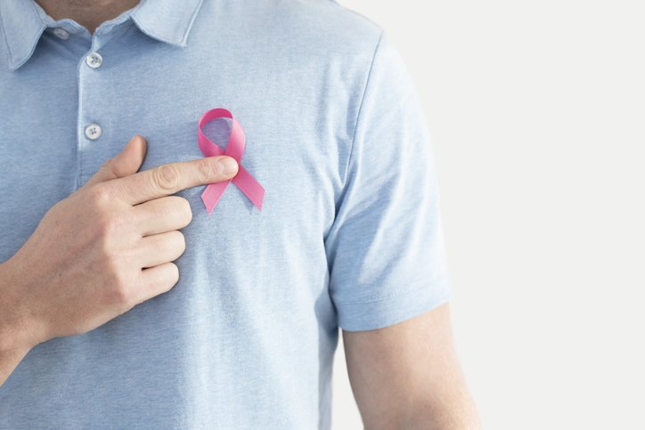 Man with pink october symbol on blue shirt - Metropolises