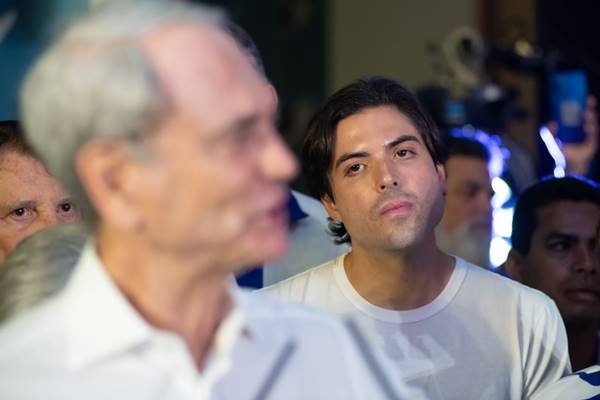 Fotografia colorida de dois rostos, um à frente embaçado e outro ao fundo em destaque