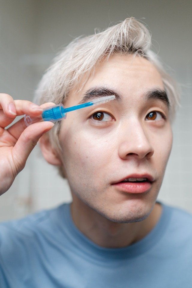 Man combing his eyebrows