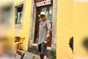 homem em frente a muro amarelo