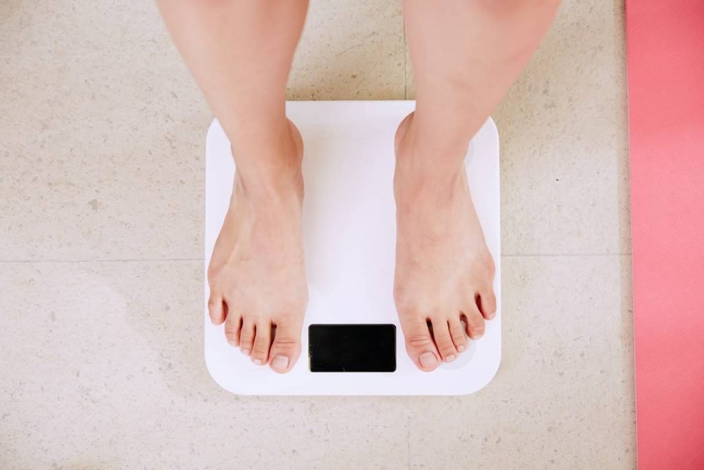 Color photo of scales.  A person trying to lose weight