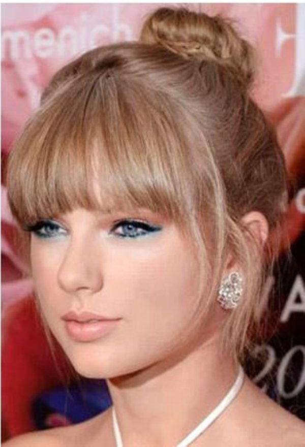 Foto colorida da Taylor Swift usando um coque alto
