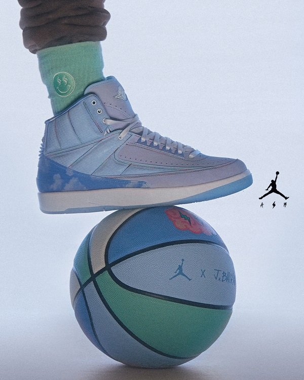 Campanha de divulgação da parceria entre a marca Jordan, do jogador de basquete Michael Jordan, com o cantor J Balvin. Os itens são feitos pela Nike. Na foto, é possível ver um tênis lilás com detalhes em branco e azul por cima de uma bola de basquete nas mesmas cores.