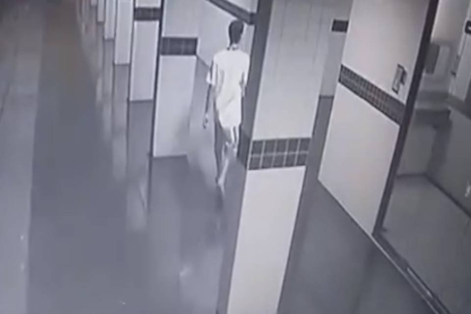 Homem de costas caminha em prédio