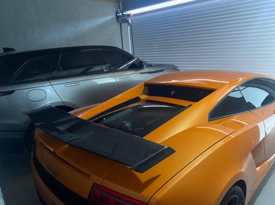 foto colorida de carro laranja e carro prateado