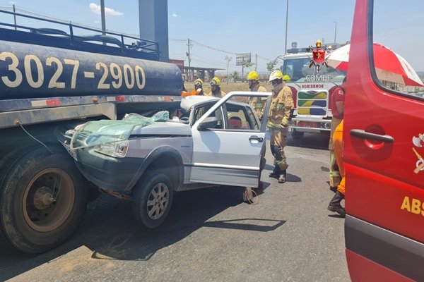 Foto de um carro embaixo de um caminhão