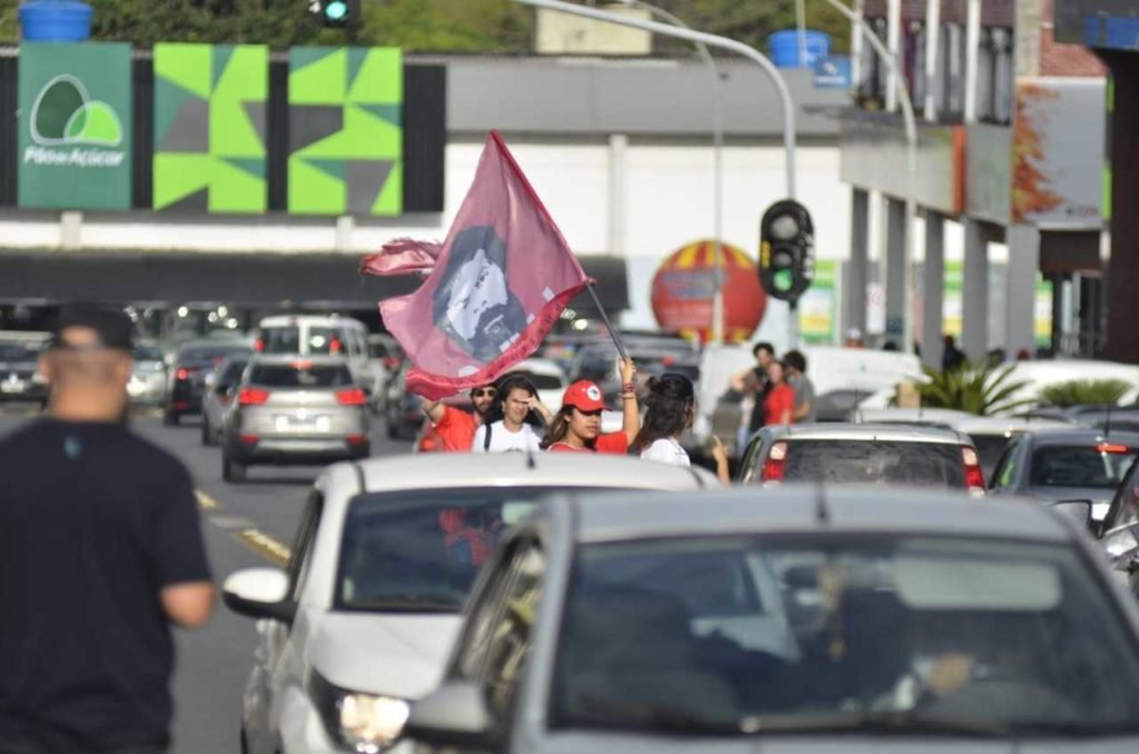 bandeiras vermelhas em meio a carros