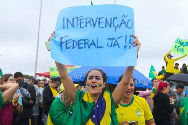 Manifestantes frustados com o resultados das eleições trocam os cartazes de “intervenção militar”por “intervenção Federal” em ato em frente ao QG do Exército