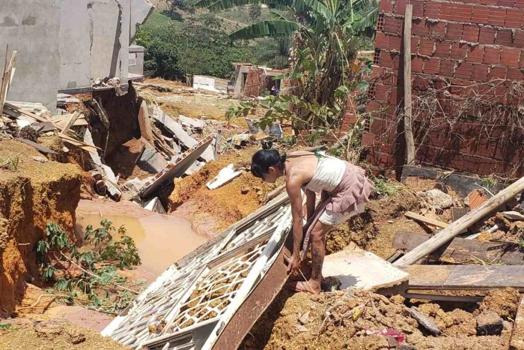 Estrago em casas no Sol Nascente, na Ceilândia, após fortes chuvas. Na foto vê-se diversos móveis estragados e muita lama em terreno baldio e mulher retirado objetos que ainda não foram danificados - Metrópoles