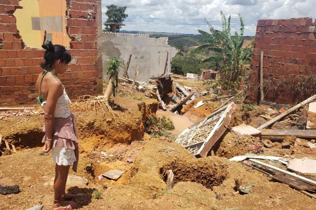 Estrago em casas no Sol Nascente, na Ceilândia, após fortes chuvas. Na foto vê-se diversos móveis estragados e muita lama em terreno baldio e mulher retirado objetos que ainda não foram danificados - Metrópoles