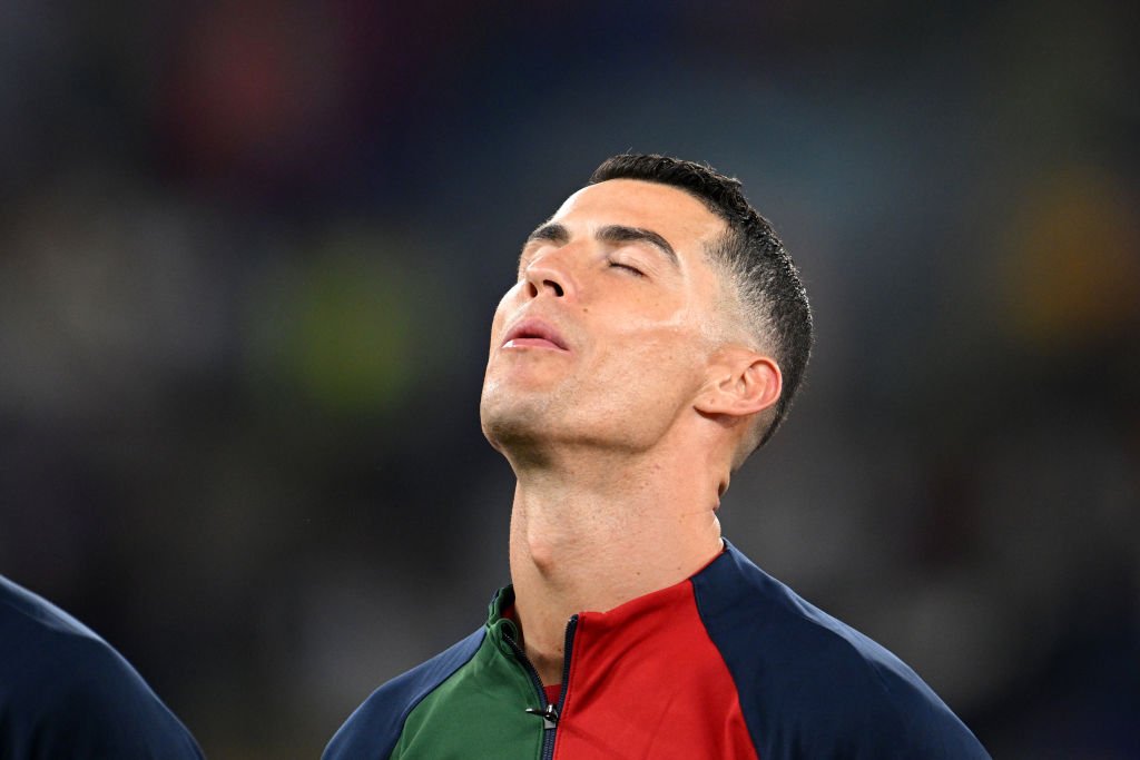 O jogador Cristiano Ronaldo chora de olhos fechados e cabeça erguida enquanto houve o hino de Portugal, antes de começar jogo contra Gana na Copa do Mundo do Catar - Metrópoles