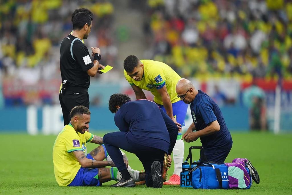 LUSAIL CITY, QATAR - NOVEMBER 24: Neymar of Brazil is attended to by medical staff during the FIFA World Cup Qatar 2022 Group G match between Brazil and Serbia at Lusail Stadium on November 24, 2022 in Lusail City