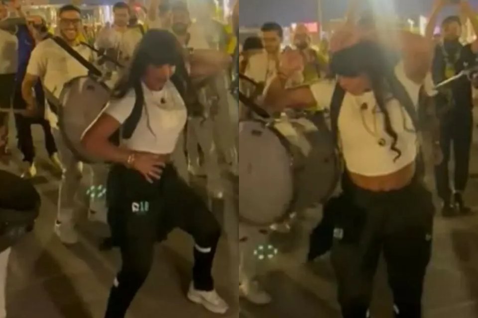 Imagens de Gretchen, de camisa branca, calça preta e cabelos pretos, dançando e rodeada por torcedores no Catar - Metrópoles
