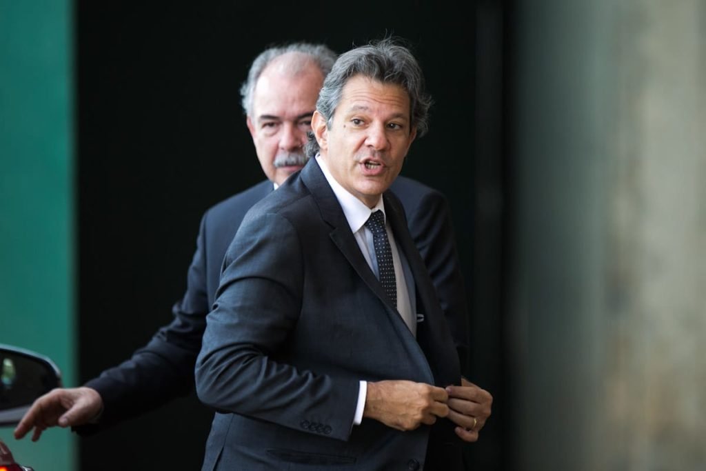 Fernando Haddad chega ao CCBB para reuniões do governo de transição. Ele fala com alguém e ajusta terno enquanto caminha na entrada - Metrópoles