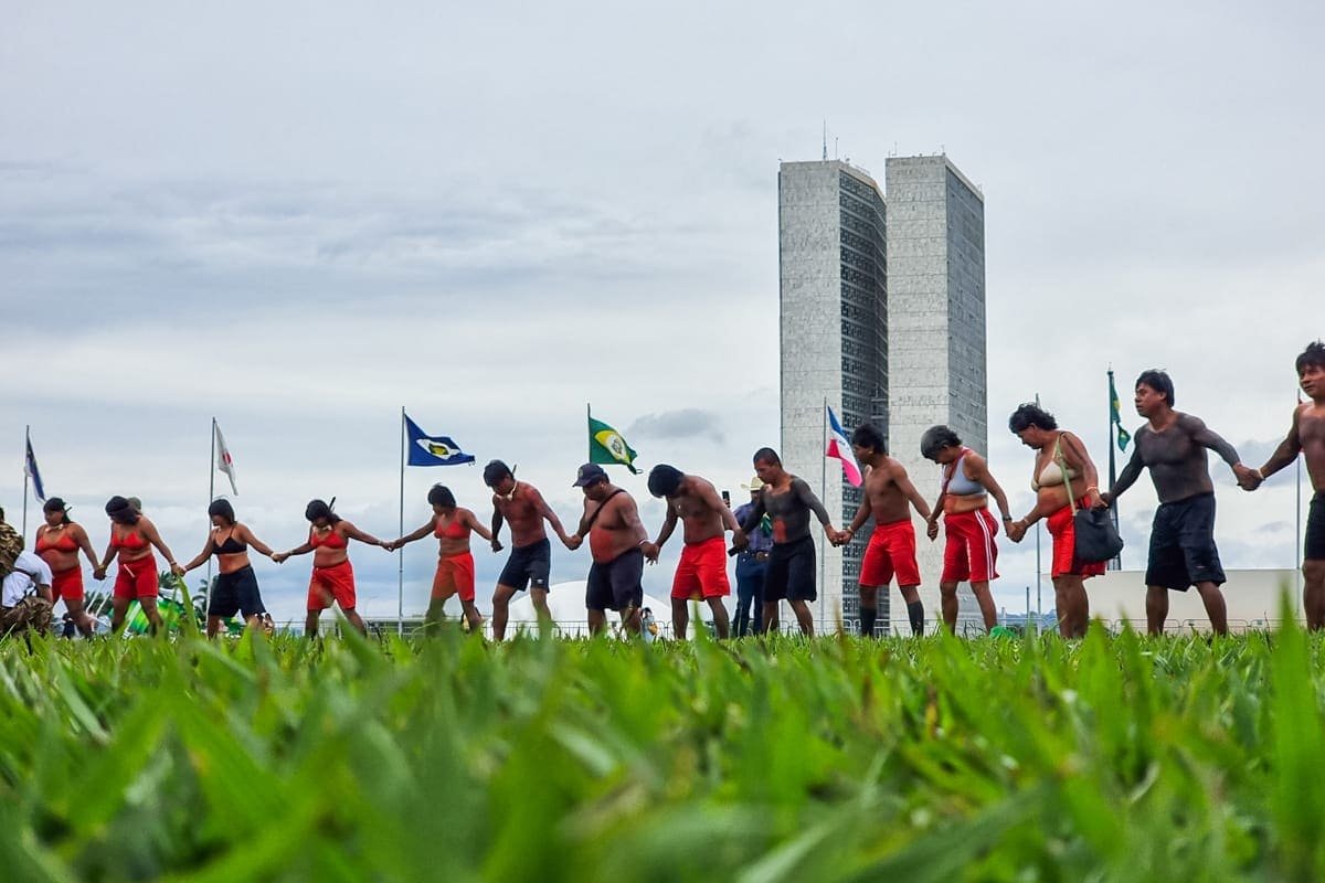 Indígenas fazem corrente com mãos em frente ao Congresso Nacional, na Esplanada dos Ministérios, protestando contra resultado das eleições presidenciais - Metrópoles