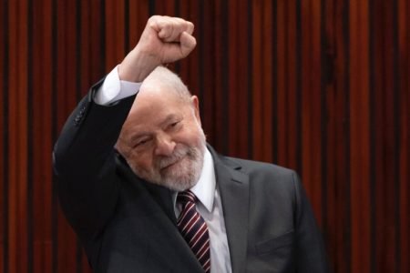 Lula, presidente eleito, sorri e ergue o punho cerrado durante cerimônia de sua diplomação no TSE - Metrópoles