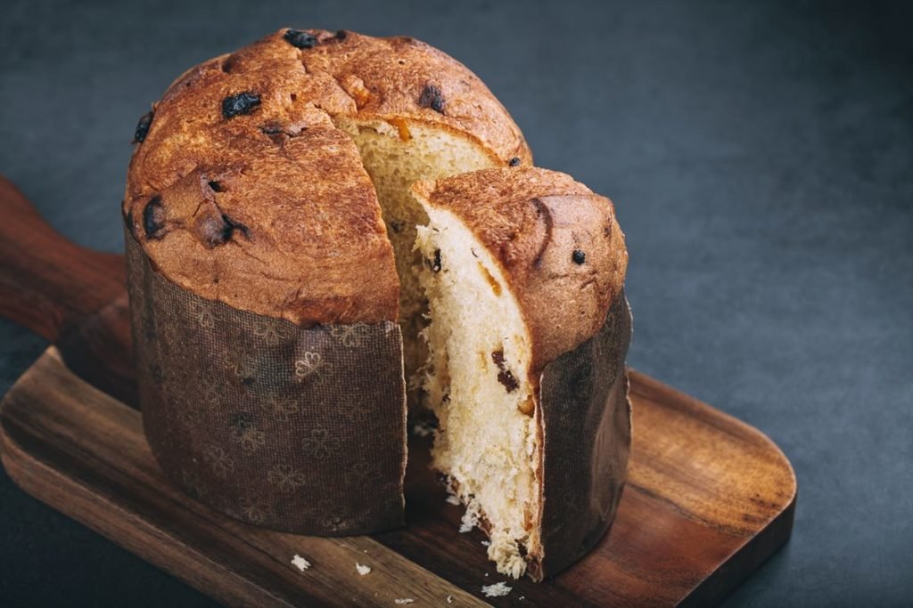 Panetone de frutas cristalizadas em cima de uma tábua de madeira