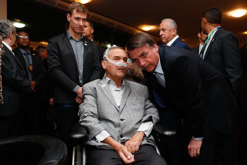 Jair Bolsonaro e conversa com o general da reserva Villas Bôas, sentado em uma cadeira de rodas e usando um tubo de ventilação no nariz - Metrópoles