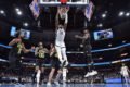Jogador do Grizzlies enterrando em partida contra o Jazz