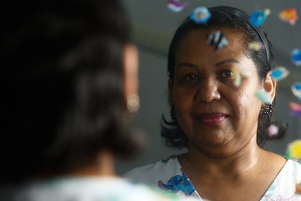 Mulher negra se olhando no espelho