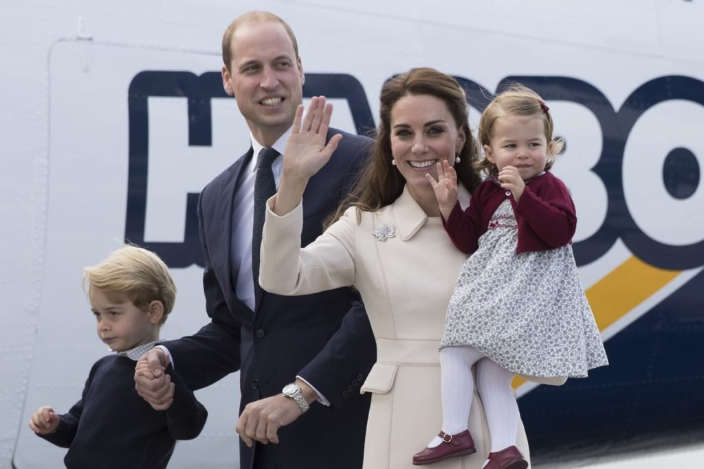 Foto colorida de homem, branco e calvo, de mãos dadas com um menino branco e loiro. Ao lado, está uma mulher que segura no colo uma menina branca, loira e com casaco vermelho Metrópoles