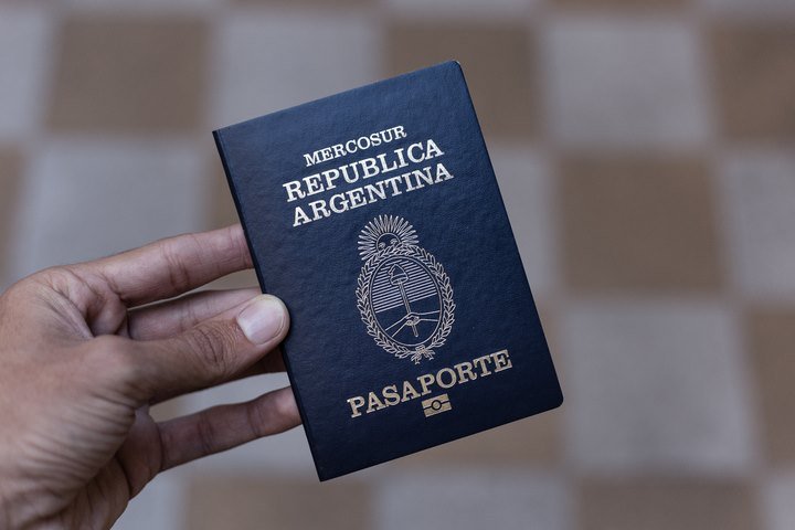 Pessoa segura passaporte da Argentina - Metrópoles