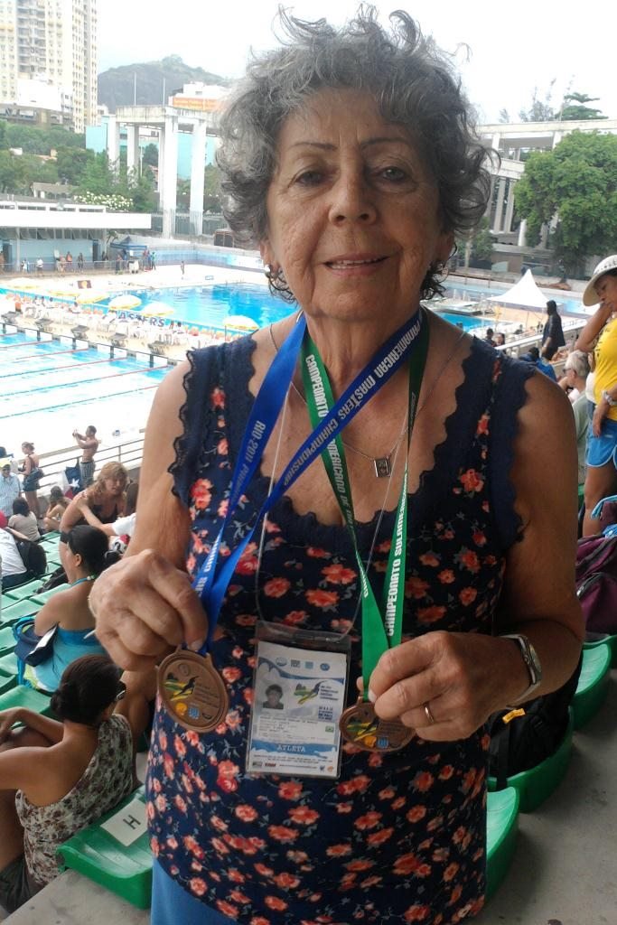 Color image: elderly woman holding medals - Metropolis
