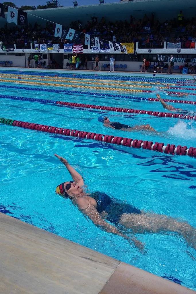 Color image: woman swimming in pool Metropolis