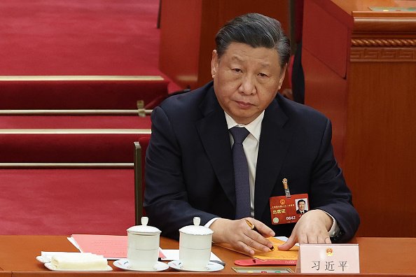 presidente da China, Xi Jinping sentado em mesa - metrópoles