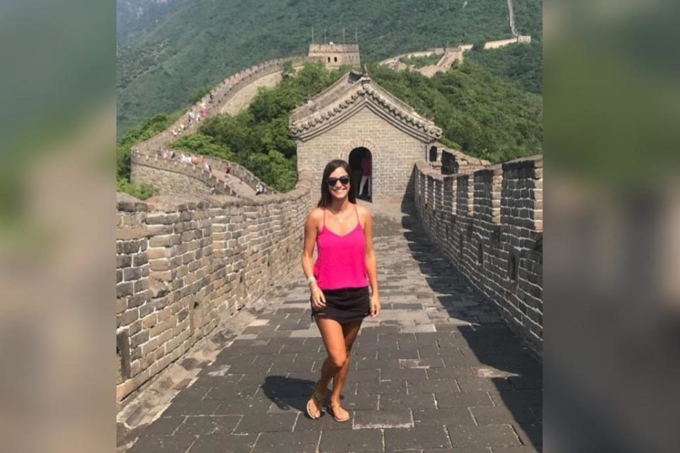 Mulher com blusa na cor rosa e shorts preto na Muralha da China - Metrópoles