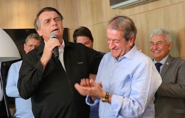 Partido Imagem colorida de Jair Bolsonaro com um microfone na mão ao lado de Valdemar Costa Neto sorrindo e aplaudindo - metrópoles