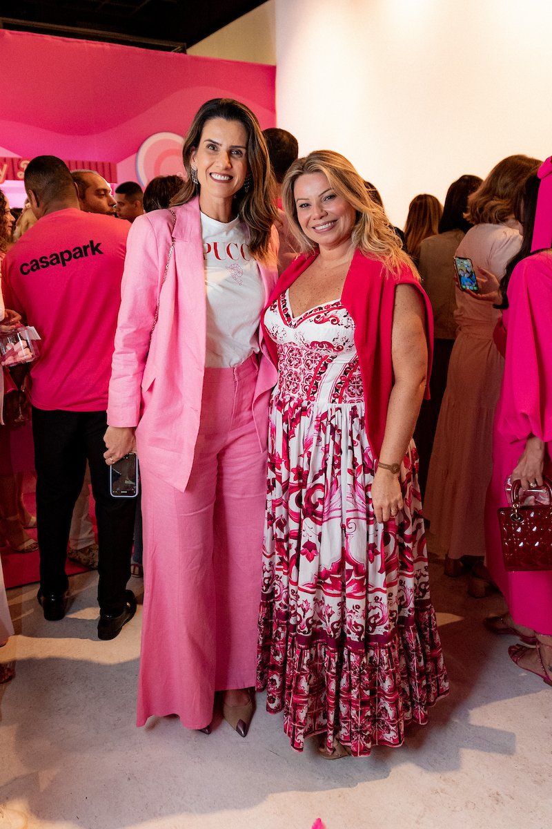 In photo, guests wearing pink at a social event in a movie theater