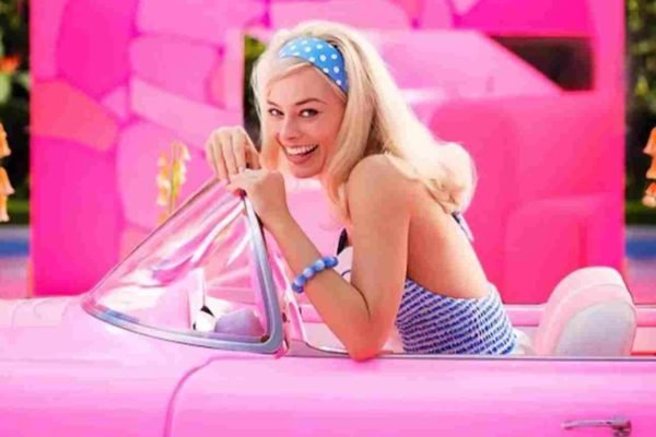 Trecho do filme Barbie. Na imagem, Margot Robbie dirige um carro rosa - Metrópoles
