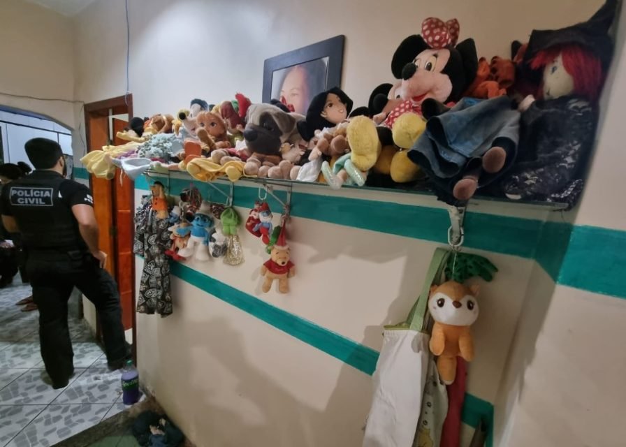 Quarto de pedófilo cheio de brinquedos em prateleira verde, anexada a parede branca