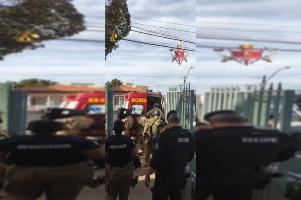Equipes dos bombeiros e da Polícia Militar do DF passam por portão em direção a uma ambulância