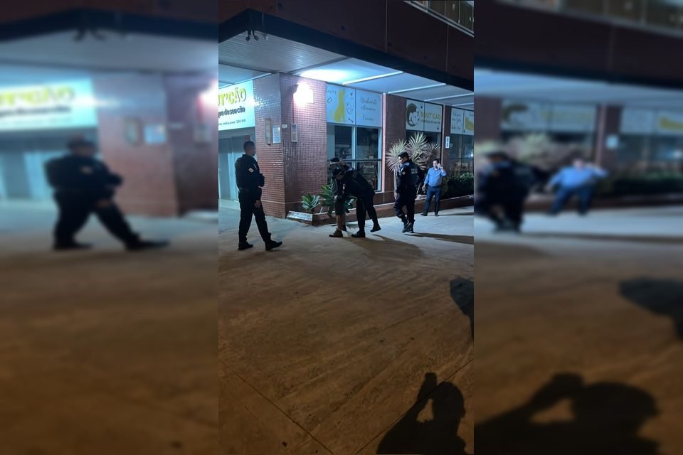 Policiais ao redor de homem sendo preso