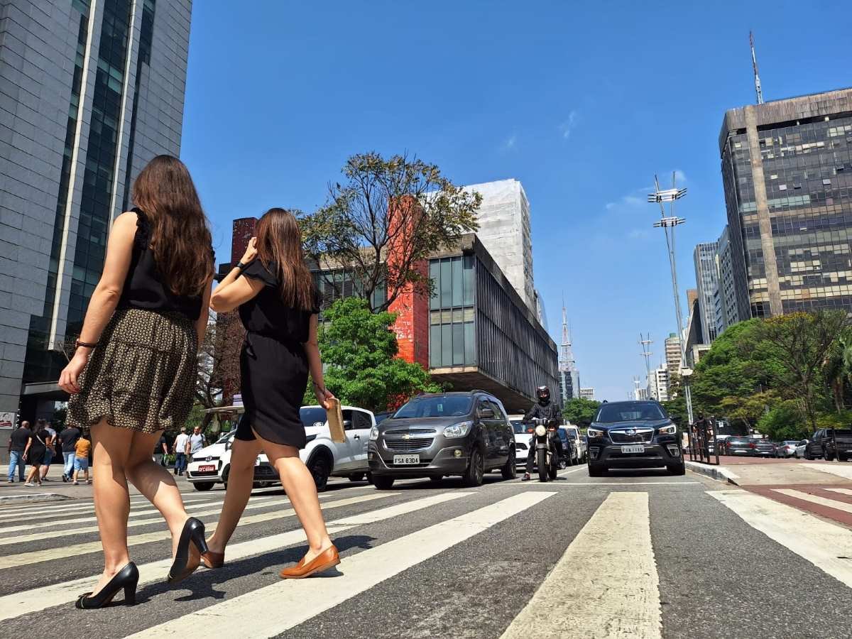 foto colorida mostra mulheres mulheres caminhando sob sol em trecho da Avenida Paulista - Metrópoles