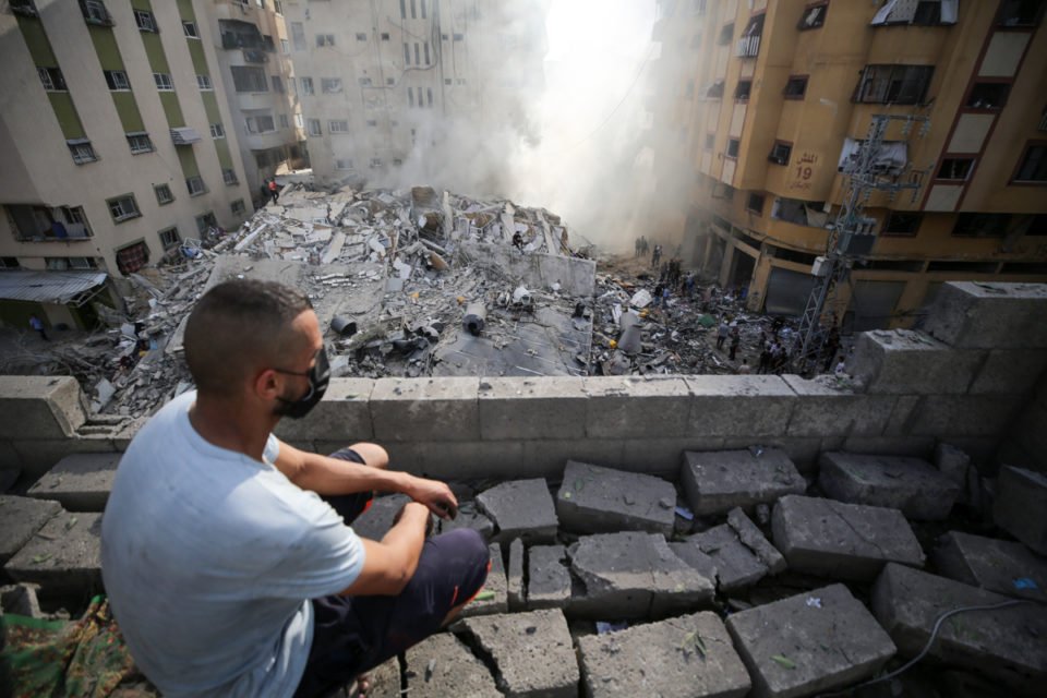 As pessoas avaliam a causa da destruição causada pelos ataques aéreos israelenses na Cidade de Gaza em 7 de outubro de 2023