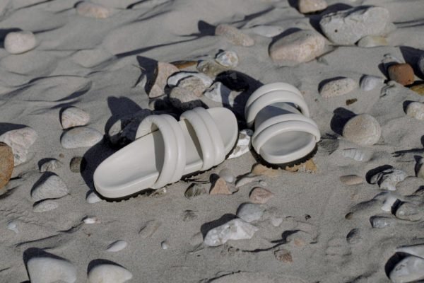 Na imagem com cor, uma sandália branca de tiras - Metrópoles 
