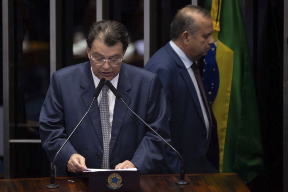Líder da oposição no Senado Rogério Marinho (PL-RN) passa atrás do relator da reforma tributária, senador Eduardo Braga (MDB AM), durante a leitura do relatório e emendas extras no plenário.