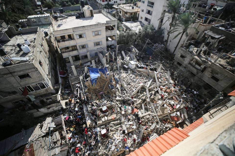Imagem colorida mostra Palestinos vasculham os escombros de um prédio desabado em busca de sobreviventes e vítimas após o bombardeio israelense de Deir el-Balah, no centro da Faixa de Gaza, contra o Hamas - Metrópoles