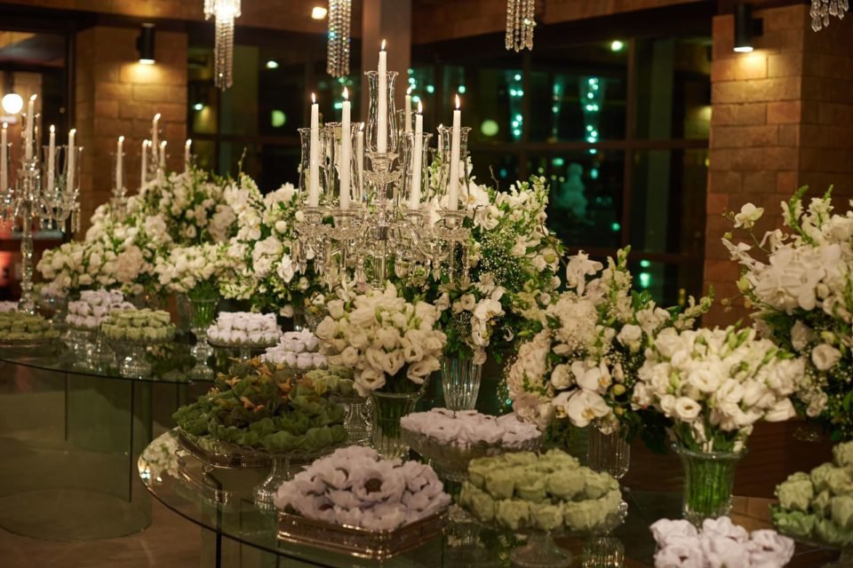 Mesa de doces de casamento com velas e flores