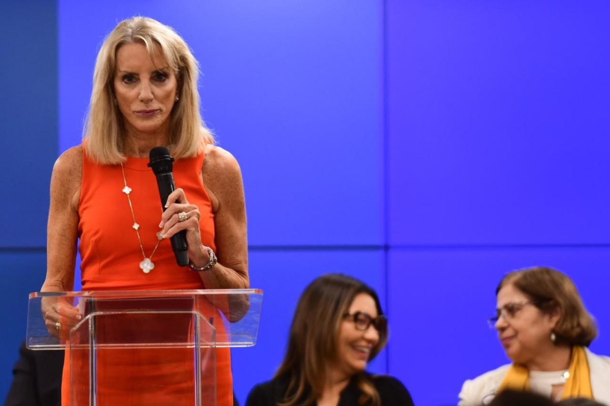 Foto colorida Embaixadora dos Estados Unidos, Elizabeth Frawley Bagley, com fundo azul - Metrópoles