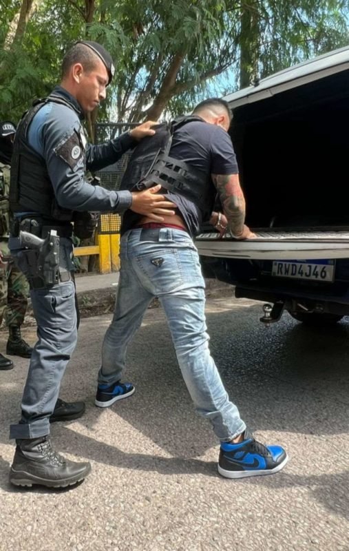 Fotografia colorida mostra Elvis Riola sendo revistado pela polícia boliviana - Metrópoles