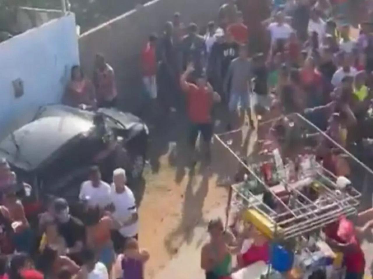Imagem colorida do momento em que um boi invade um bloco de carnaval - Metrópoles